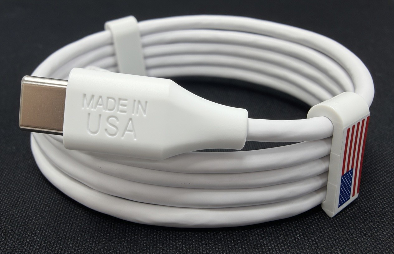 A white USB-C charging cable from Spearhead's first U.S. production run. One connector is embossed 'Made in USA' and the other is marked with an American flag.