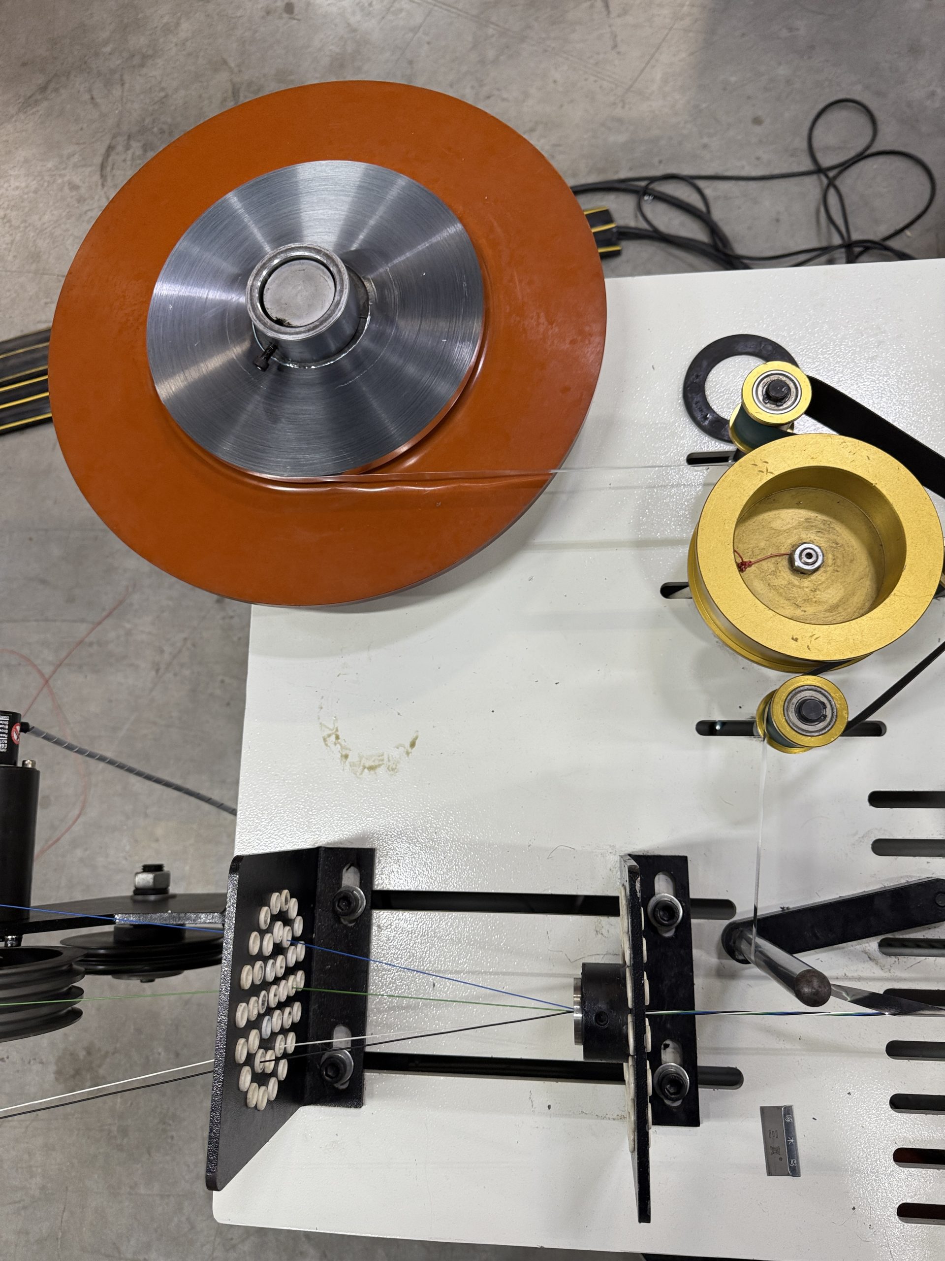 Mylar tape shielding being applied to the cable