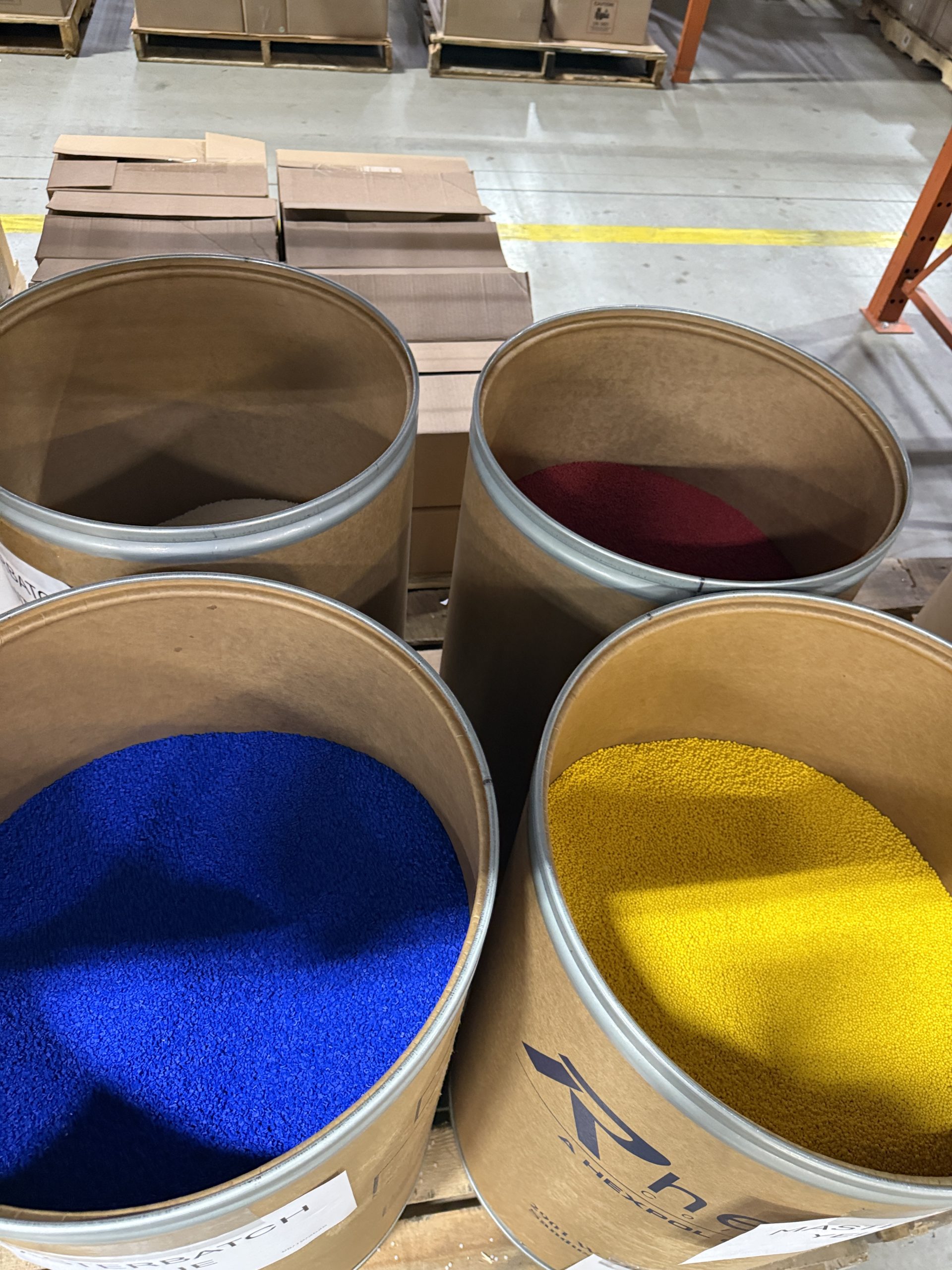 Plastic master batch pellets in blue, yellow and red - provides coloring