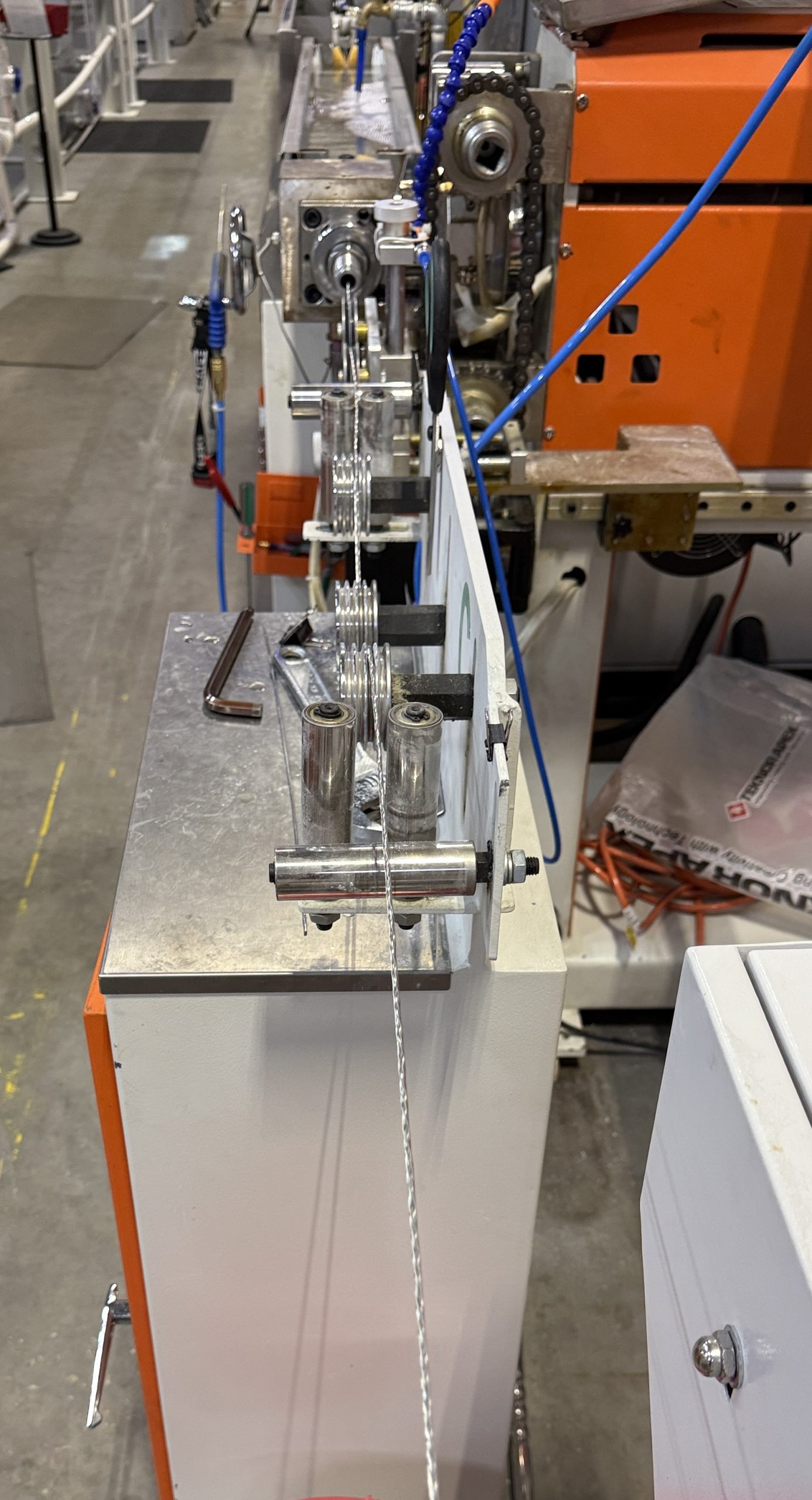 Final extrusion jacket line pulling the finished cable through the cooling and take-up rollers
