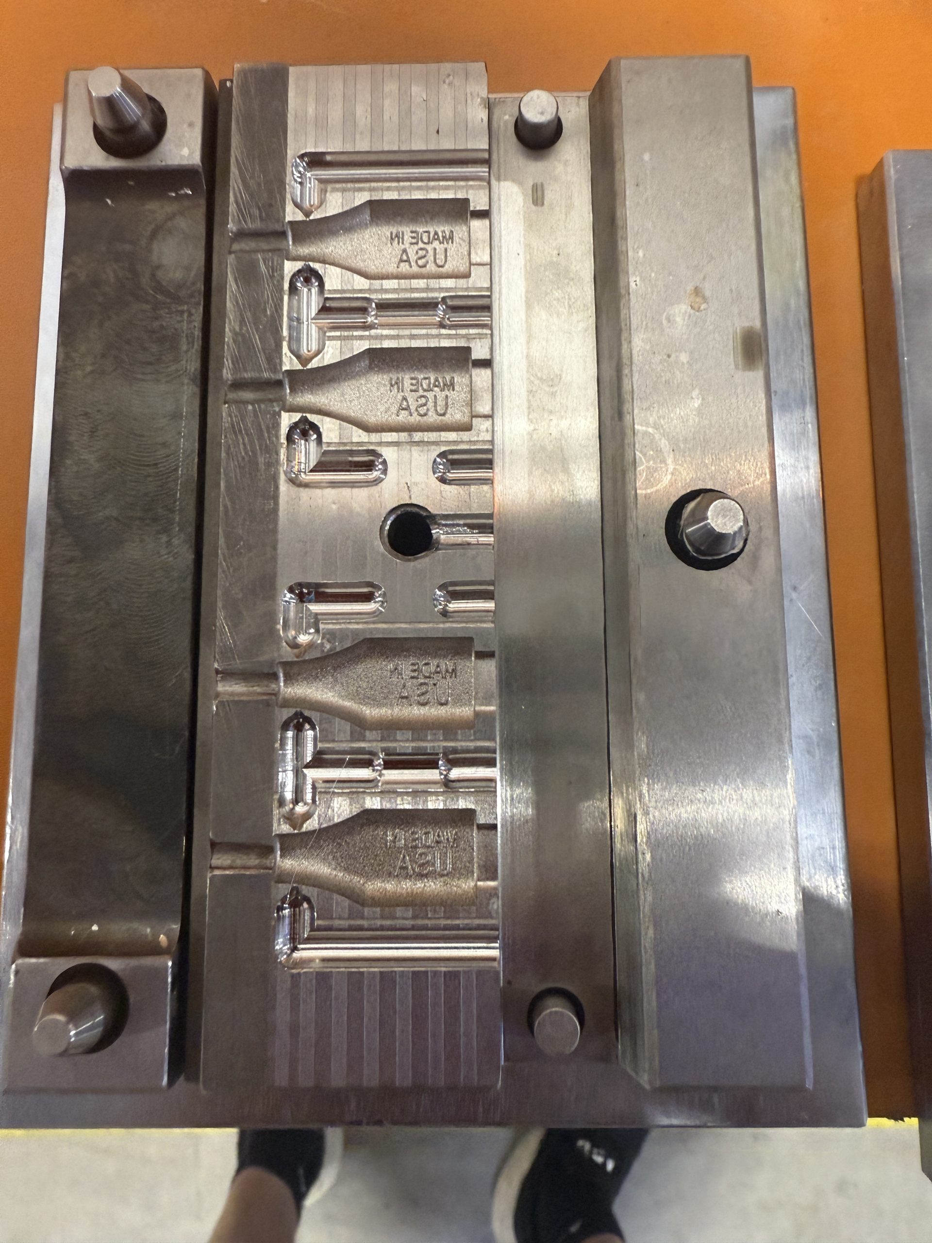Steel stamping mold engraved with MADE IN USA cavities for cable connector overmolding